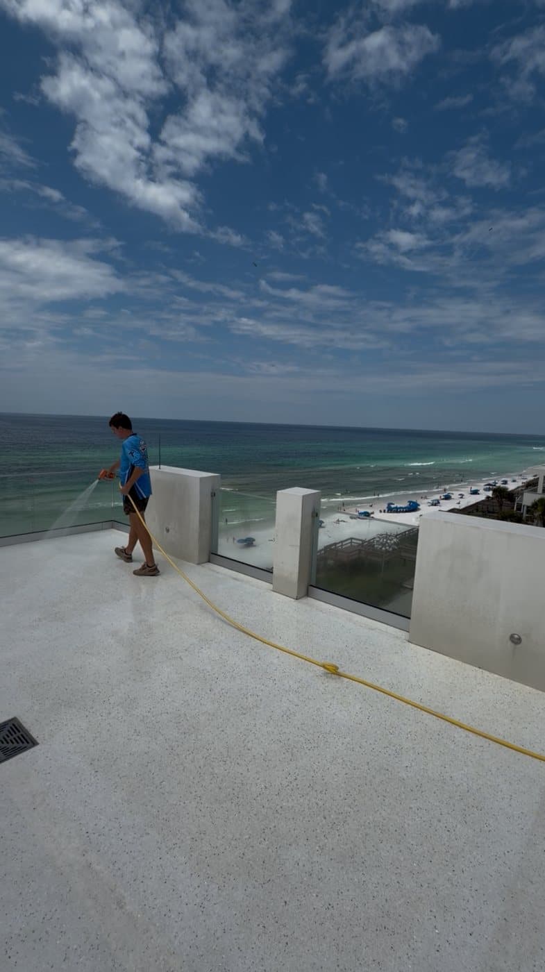 Rinsing a Gulf-front rooftop deck